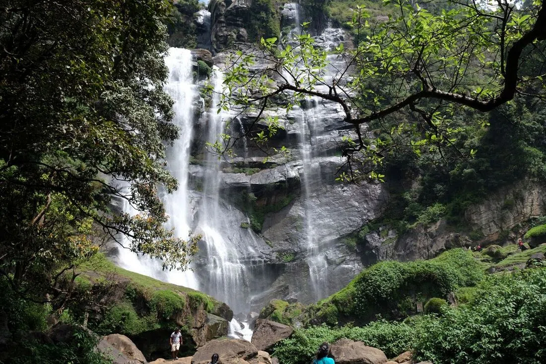 Tea-covered hills and a waterfall near Nuwara Eliya